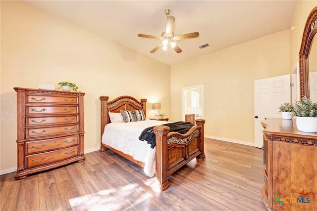 133 Ridgewood Cv, Georgetown, TX 78633 - bedroom with light wood-style flooring, vaulted ceiling, baseboards, and a ceiling fan