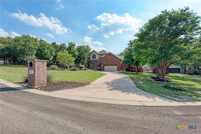 133 Ridgewood Cv, Georgetown, TX 78633 - obstructed view of property featuring a front lawn, concrete driveway, and an attached garage