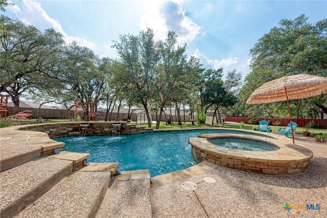 133 Ridgewood Cv, Georgetown, TX 78633 - view of swimming pool featuring a fenced backyard, a patio area, and a pool with connected hot tub