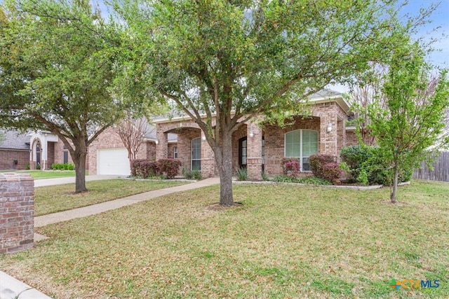 view of property hidden behind natural elements with a front yard and a garage