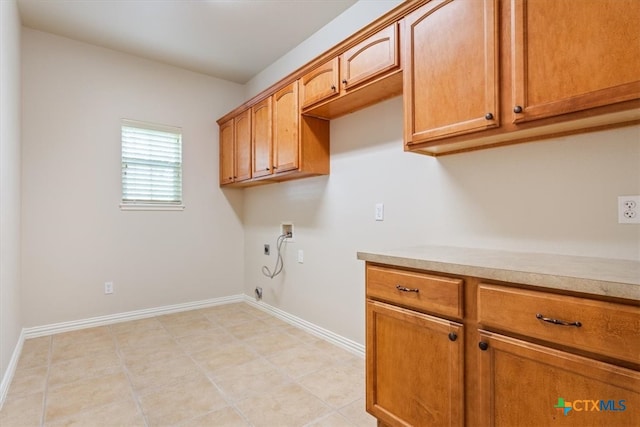 laundry room featuring washer hookup, hookup for a gas dryer, light tile patterned floors, cabinets, and electric dryer hookup