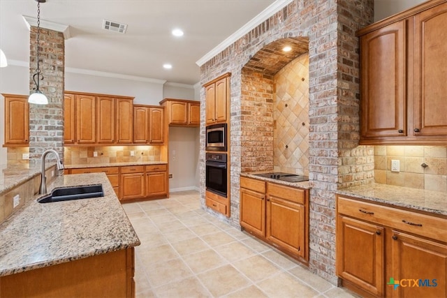 kitchen with black appliances, hanging light fixtures, sink, and tasteful backsplash