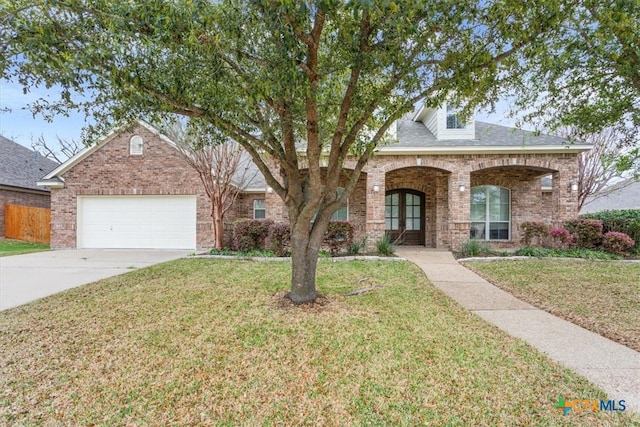 view of front of home featuring a garage and a front lawn