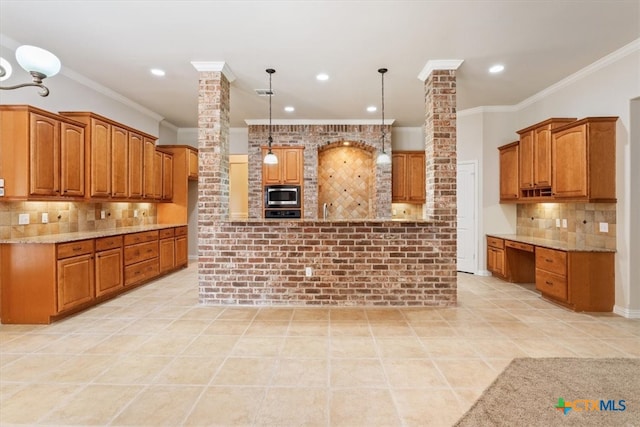 kitchen featuring backsplash, light tile patterned floors, ornate columns, pendant lighting, and stainless steel microwave