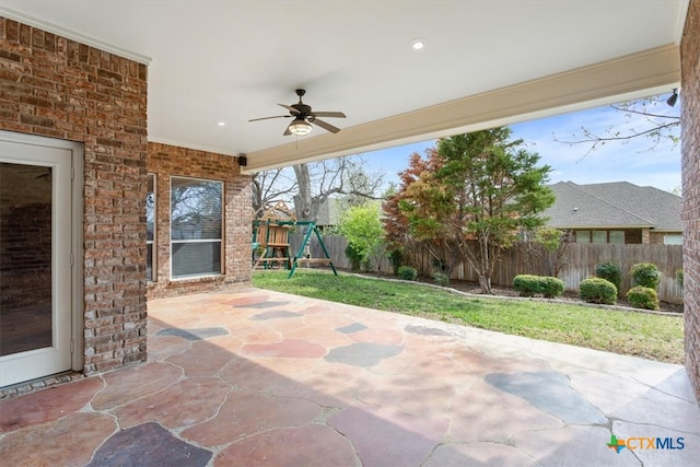 view of patio / terrace with ceiling fan and a playground