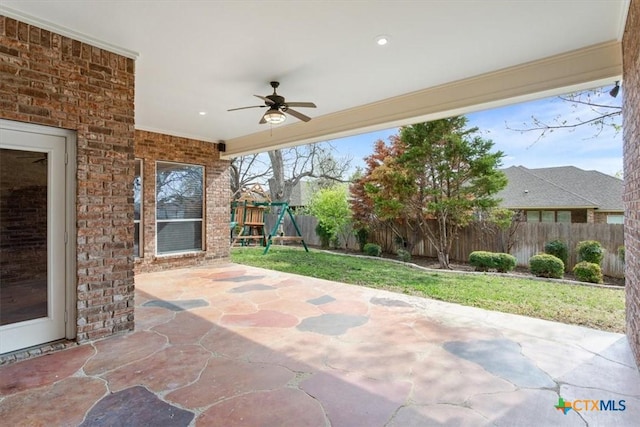 5909 Turtle Creek Trl, Temple, TX 76502 - view of patio featuring a ceiling fan, a fenced backyard, and a playground