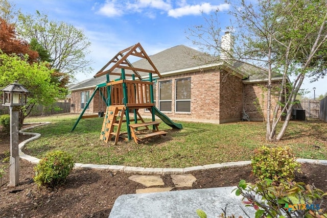 view of playground with central AC and a lawn