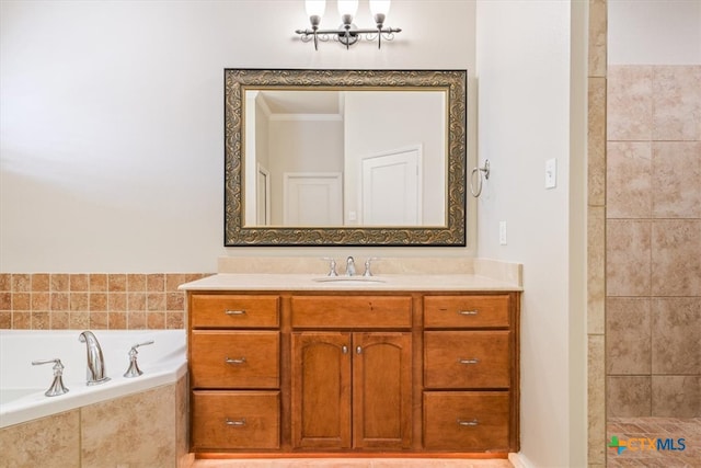 bathroom featuring vanity, tiled tub, and ornamental molding