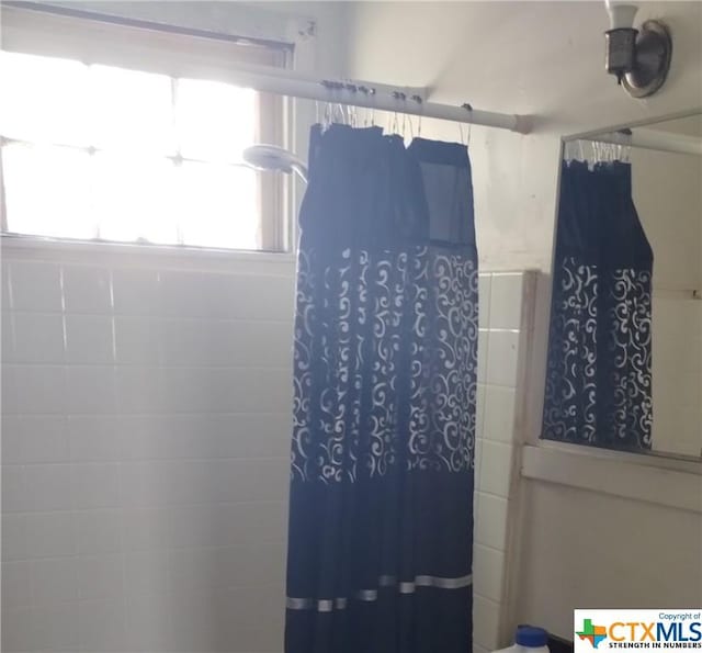 bathroom with a shower with curtain