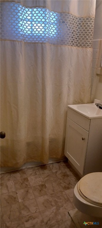 bathroom with toilet and vanity