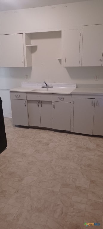 kitchen with light countertops, light floors, and open shelves