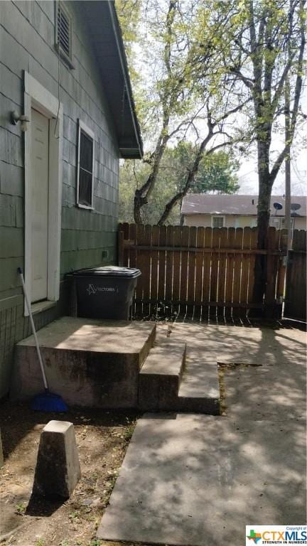 view of patio featuring fence