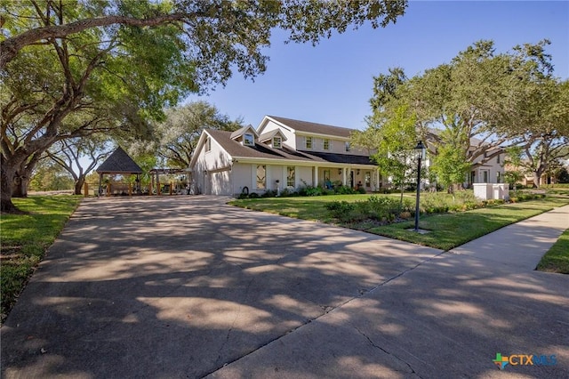 6115 Country Club Dr, Victoria, TX 77904 - view of front of property with concrete driveway, a gazebo, and a front yard