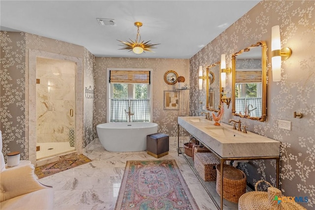 6115 Country Club Dr, Victoria, TX 77904 - full bathroom featuring a stall shower, a freestanding bath, wallpapered walls, marble finish flooring, and double vanity