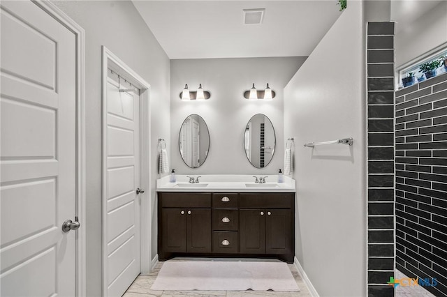 bathroom featuring double vanity, marble finish floor, visible vents, and a sink