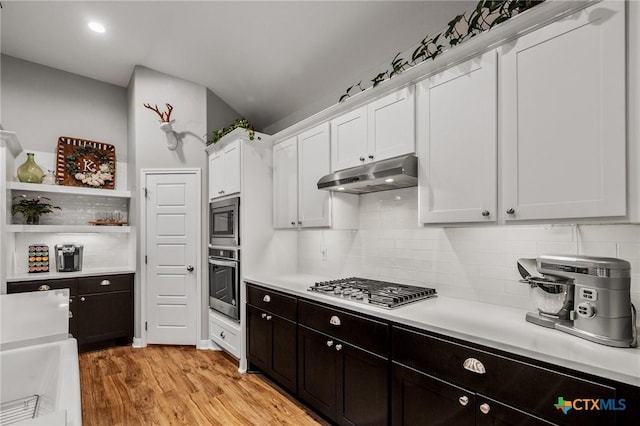 kitchen featuring under cabinet range hood, appliances with stainless steel finishes, white cabinetry, and light countertops