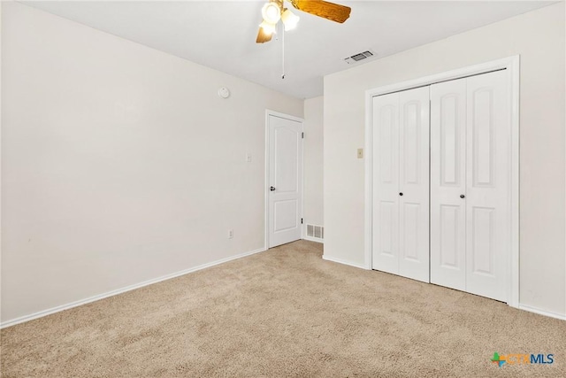 unfurnished bedroom featuring carpet, visible vents, and baseboards