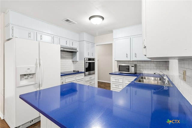 kitchen featuring visible vents, a sink, stainless steel appliances, white cabinets, and under cabinet range hood