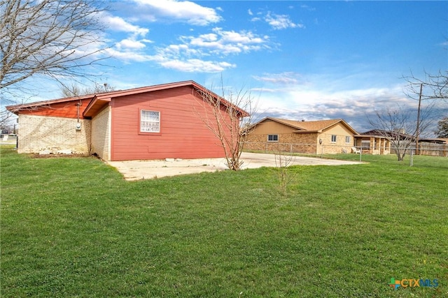 view of side of home featuring a lawn