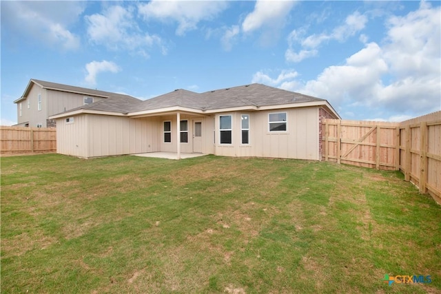 back of property featuring a patio, a fenced backyard, and a lawn