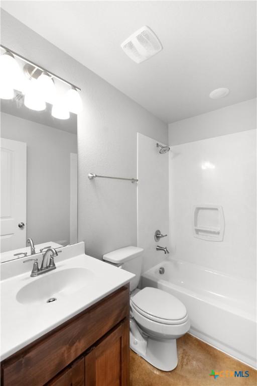 bathroom featuring bathing tub / shower combination, vanity, visible vents, and toilet