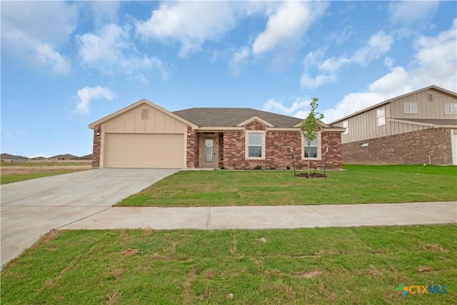 view of front facade featuring brick siding, a front lawn, a garage, and driveway