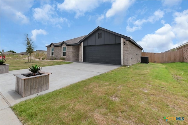 3104 Goblin Dr, Killeen, TX 76549 - view of front of property with board and batten siding, a garage, concrete driveway, and brick siding