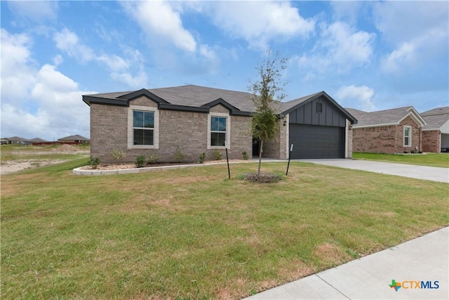 3104 Goblin Dr, Killeen, TX 76549 - single story home featuring driveway, board and batten siding, brick siding, an attached garage, and a front lawn