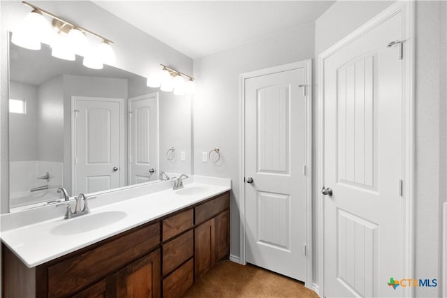 full bathroom with double vanity and a sink