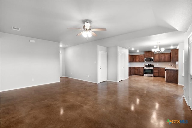 unfurnished living room with ceiling fan with notable chandelier, concrete flooring, baseboards, and visible vents