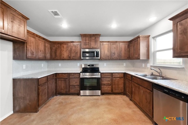 kitchen featuring visible vents, a sink, recessed lighting, stainless steel appliances, and decorative backsplash