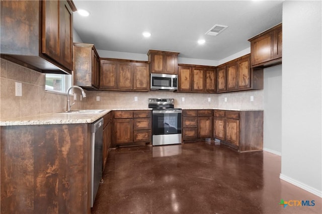 3104 Goblin Dr, Killeen, TX 76549 - kitchen featuring stainless steel appliances, finished concrete floors, backsplash, recessed lighting, and light stone countertops