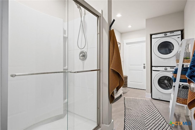 laundry area featuring stacked washer and dryer, laundry area, and recessed lighting