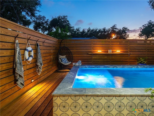 view of pool at dusk