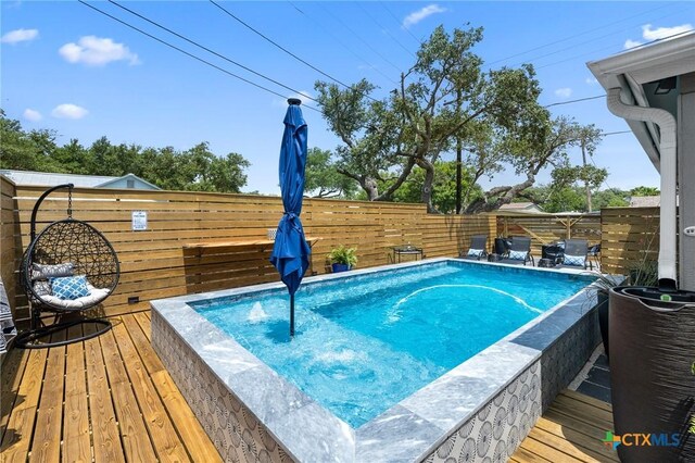 view of swimming pool featuring a fenced backyard