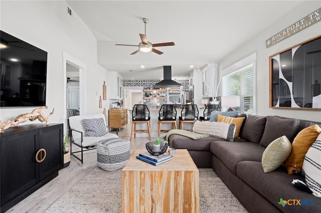 living area featuring recessed lighting, wood finished floors, and a ceiling fan