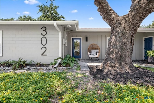 entrance to property featuring concrete block siding and board and batten siding