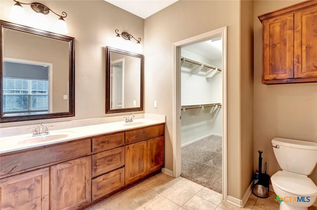 bathroom with tile patterned flooring, vanity, and toilet