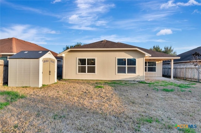 rear view of house featuring a storage unit and a patio