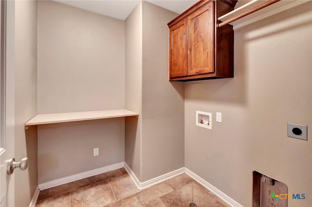 laundry area featuring cabinets, light tile patterned flooring, electric dryer hookup, and washer hookup