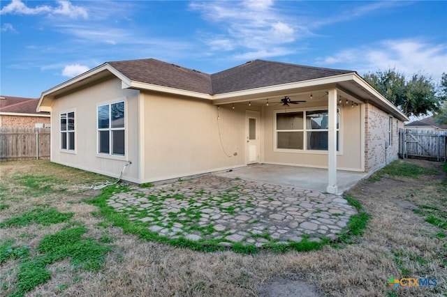 rear view of property with a patio and ceiling fan