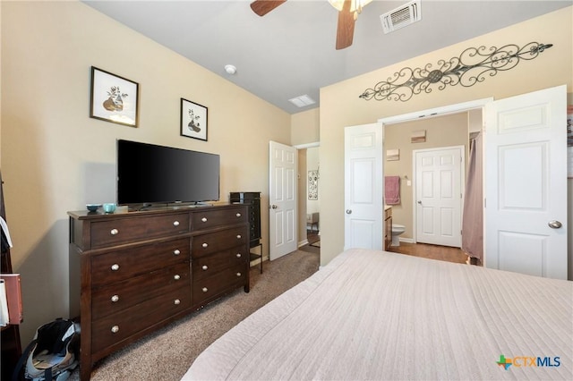 bedroom featuring ensuite bath, visible vents, carpet, and ceiling fan