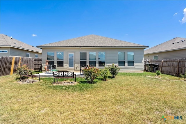 back of house with a fenced backyard, a yard, and a patio