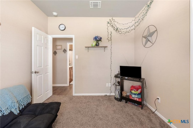 interior space featuring baseboards, visible vents, and carpet