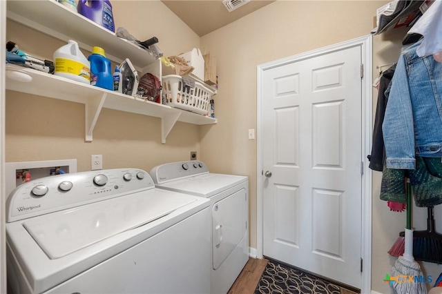 washroom with washer and dryer, visible vents, wood finished floors, and laundry area