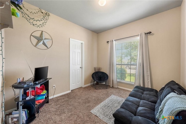 carpeted living room with baseboards