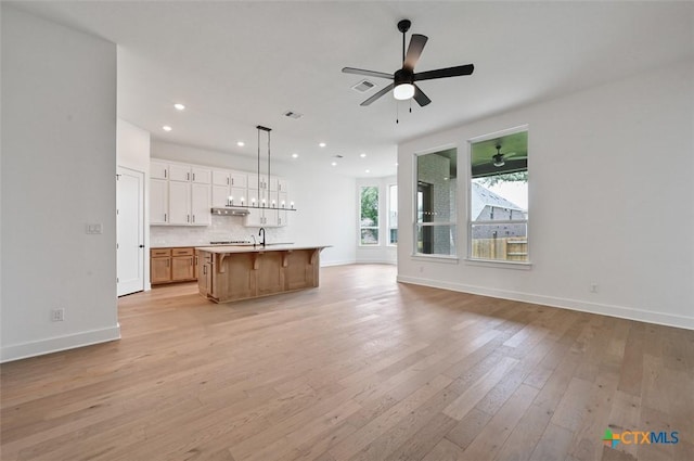 367 Five Mile Creek Way, Kyle, TX 78640 - unfurnished living room featuring light wood-style floors, recessed lighting, and a ceiling fan