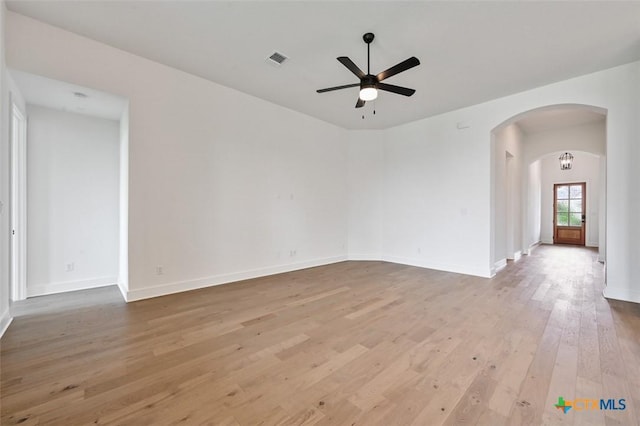 367 Five Mile Creek Way, Kyle, TX 78640 - spare room with ceiling fan, arched walkways, and hardwood / wood-style floors