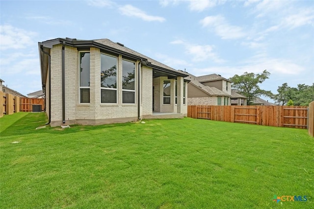 367 Five Mile Creek Way, Kyle, TX 78640 - back of property with brick siding and a fenced backyard