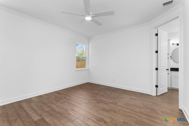 spare room with light hardwood / wood-style floors, crown molding, and ceiling fan